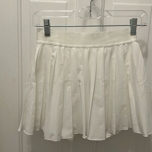White pleated skirt with shorts underneath. Size small (4-6). NWT.